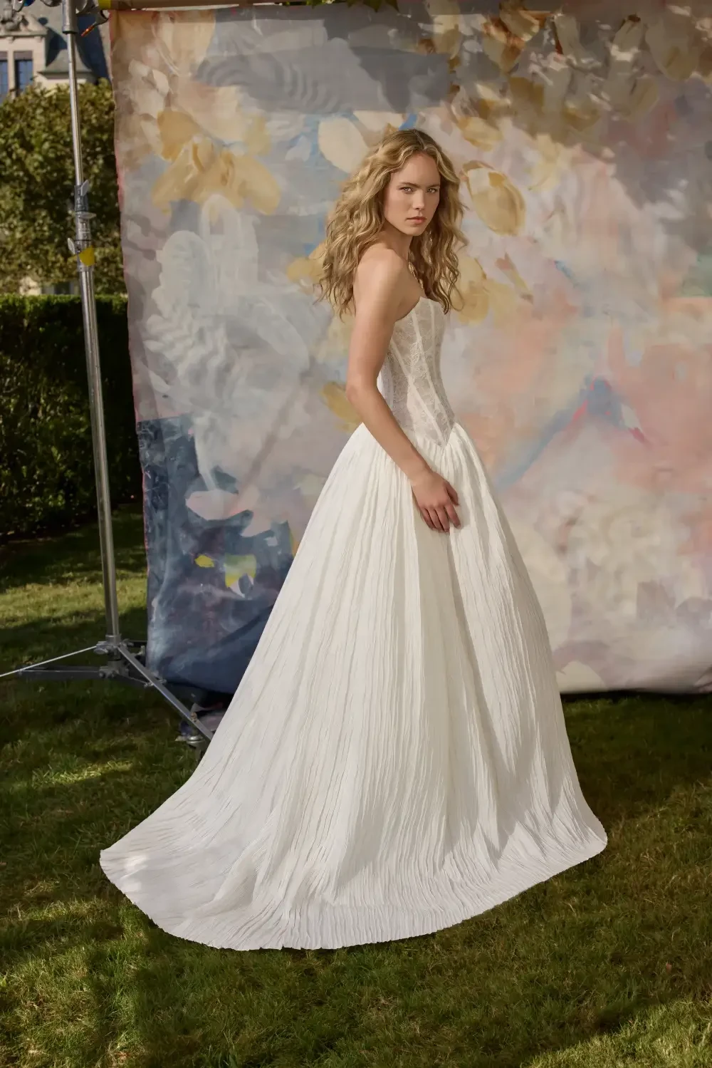 model is wearing a sleeveless ball gown wedding dress
