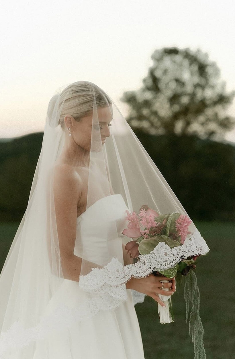 Model wearing a bridal dress with flowers